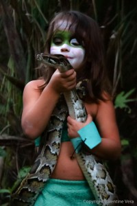 CHILD TALKING TO A SNAKE merges the animal kingdom with humans in an imaginary world created by the artist Valentine Vera